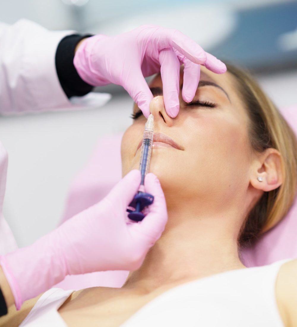 doctor-performing-rhinoplasty-by-injection-of-hyaluronic-acid-in-the-nose-of-his-patient-1.jpg doctor-performing-rhinoplasty-by-injection-of-hyaluronic-acid-in-the-nose-of-his-patient-1.jpg